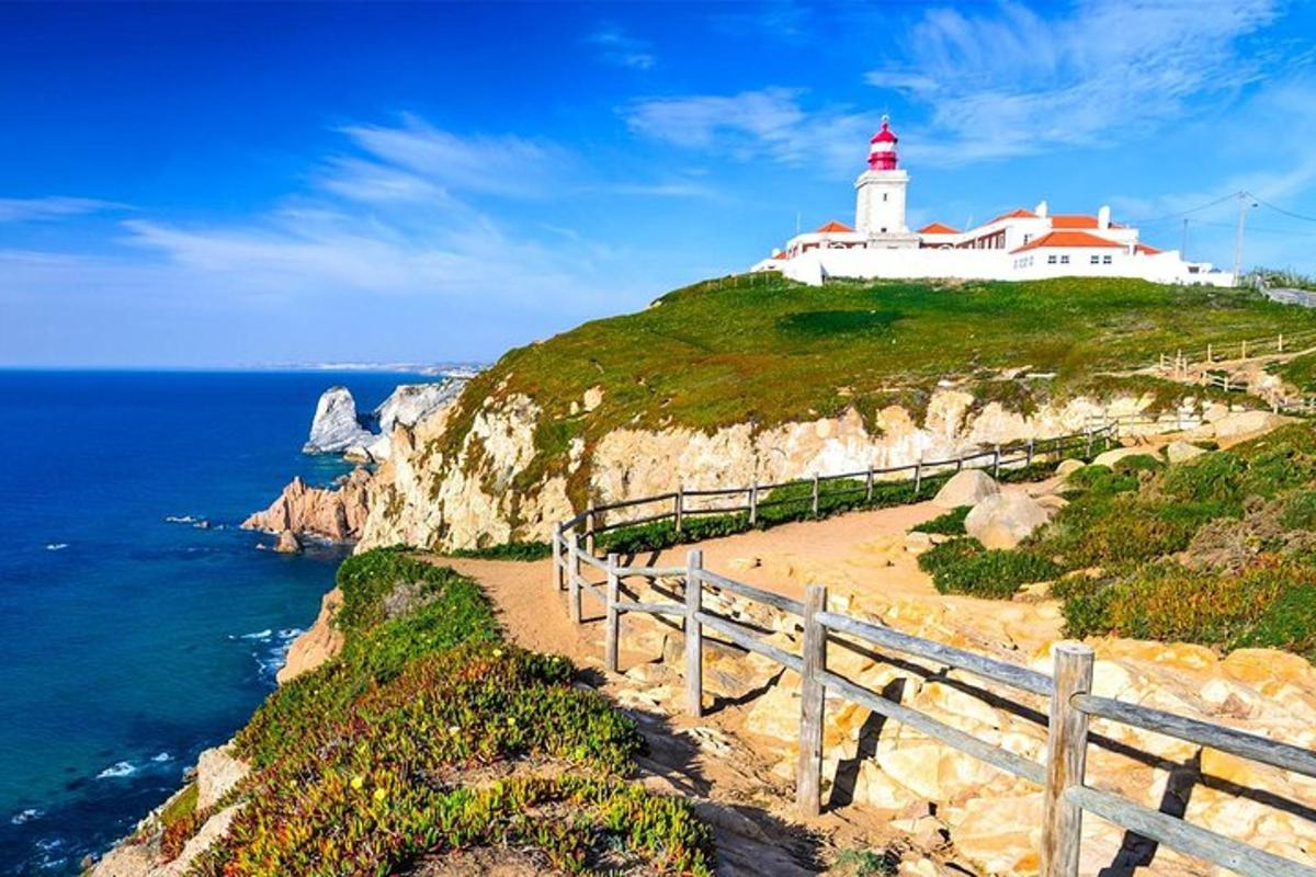 a lighthouse on a cliff next to the ocean