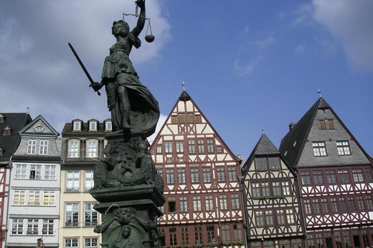 a statue in front of a group of buildings