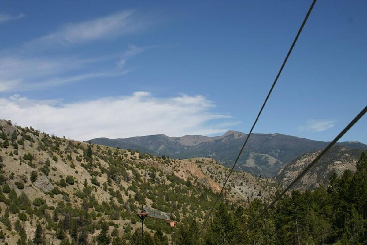 a view of a mountain with trees and mountains