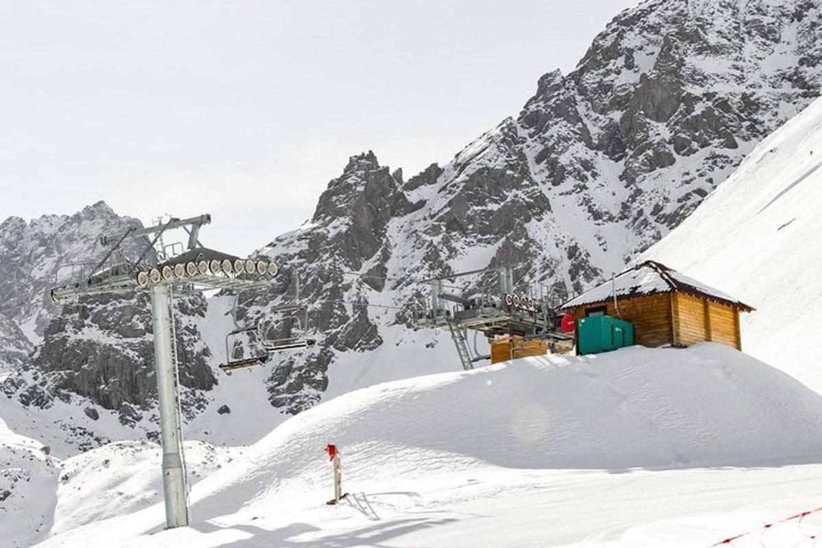 a snow covered mountain with a ski lift and a sign
