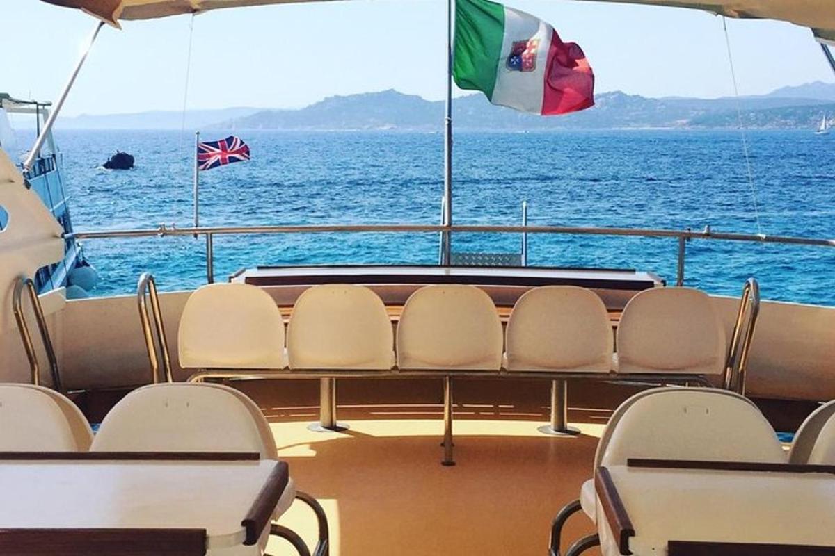 a table and chairs on a boat in the water