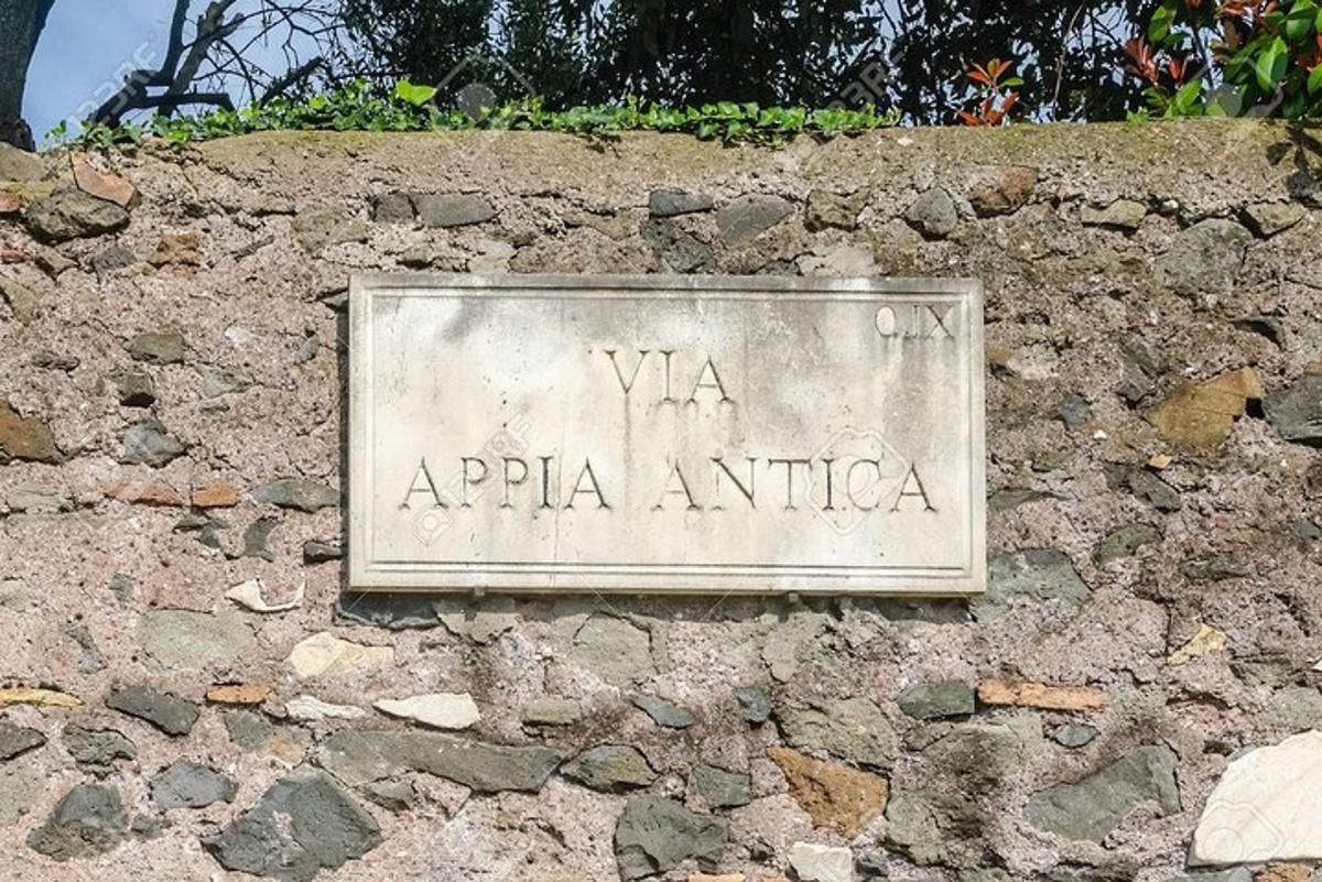 a stone sign on a stone wall