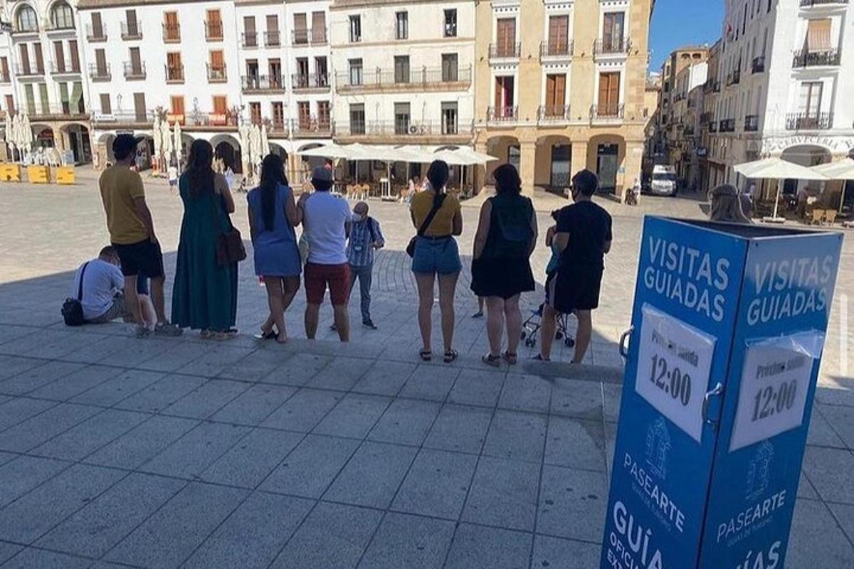a group of people standing around in a street