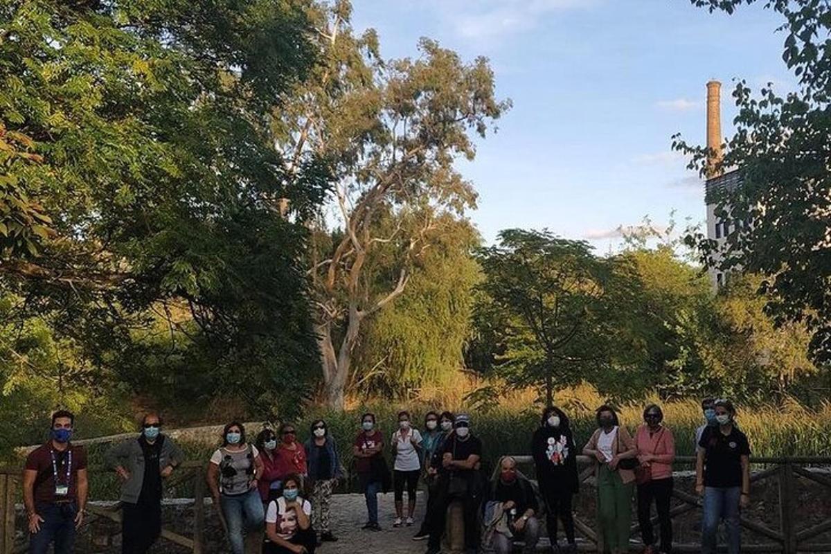 a group of people standing next to a fence