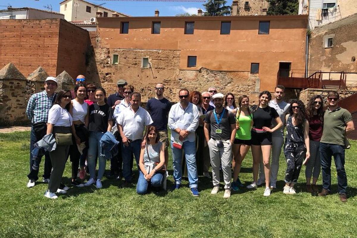 a group of people posing for a picture in front of a building