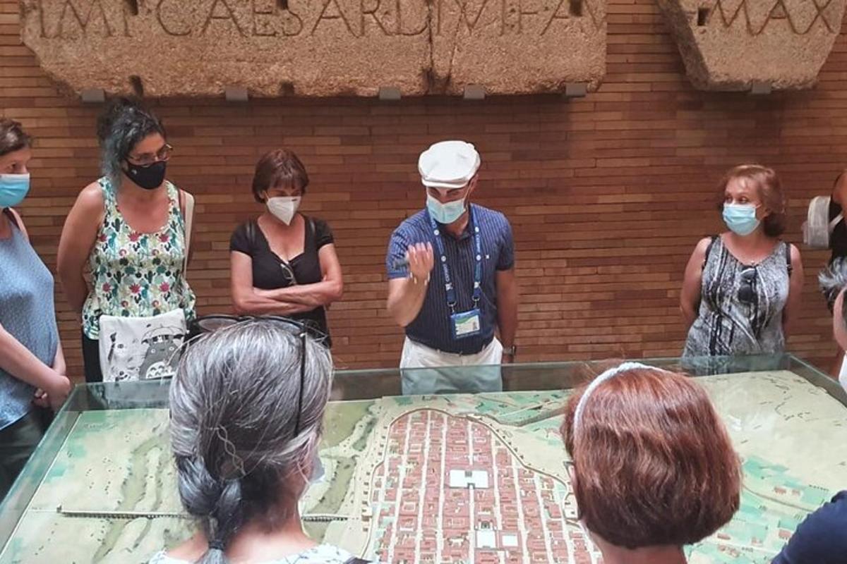 a group of people wearing face masks looking at a glass table