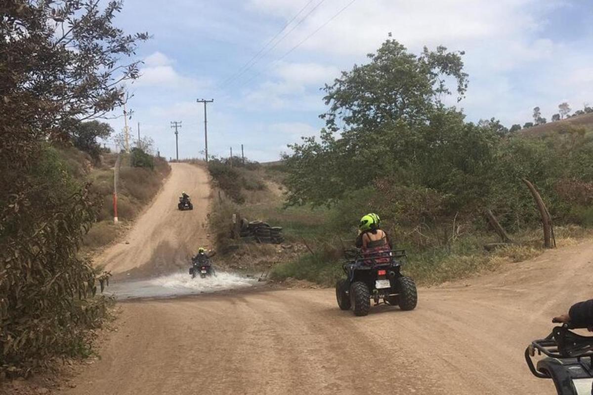 a group of people riding motorcycles on a dirt road
