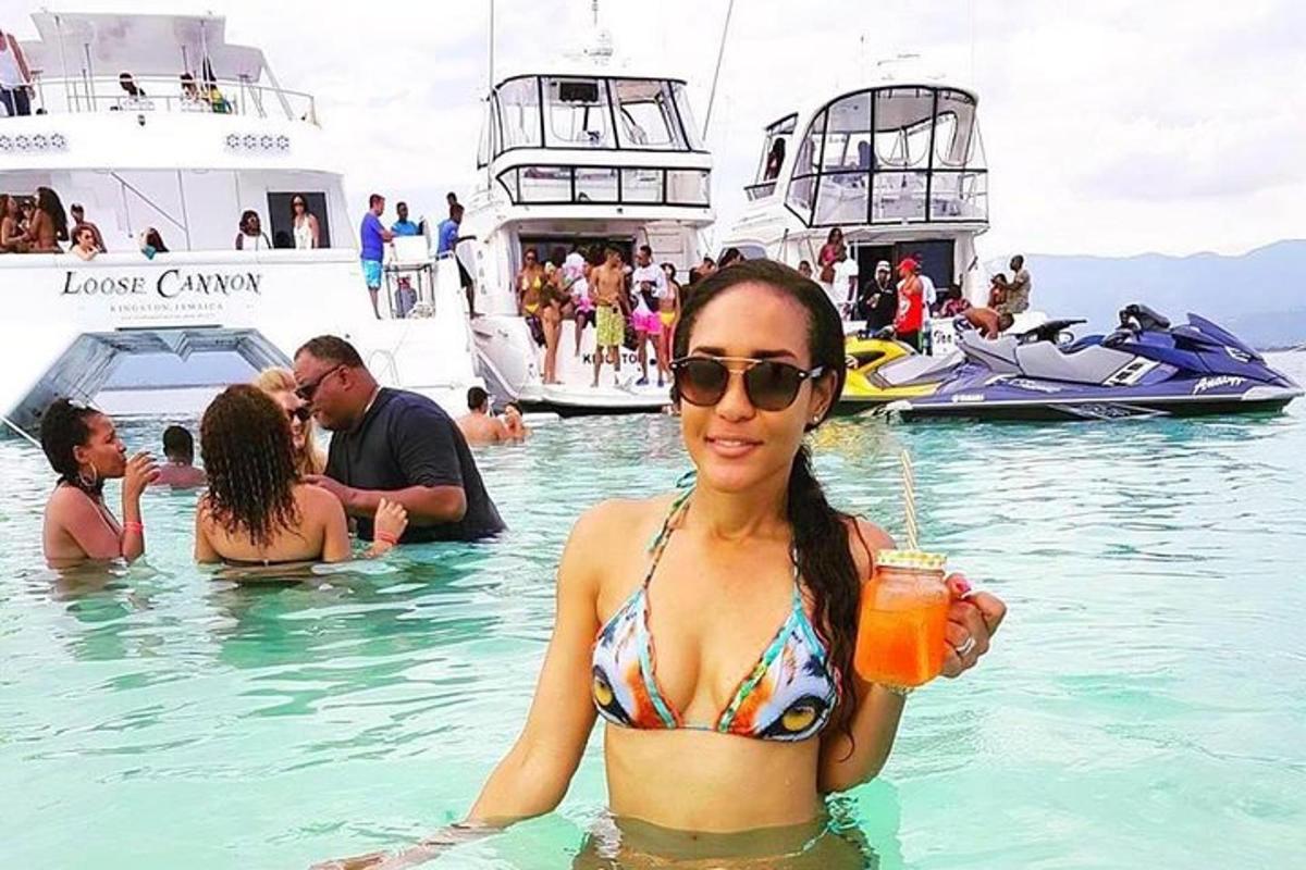 a woman in the water with a drink