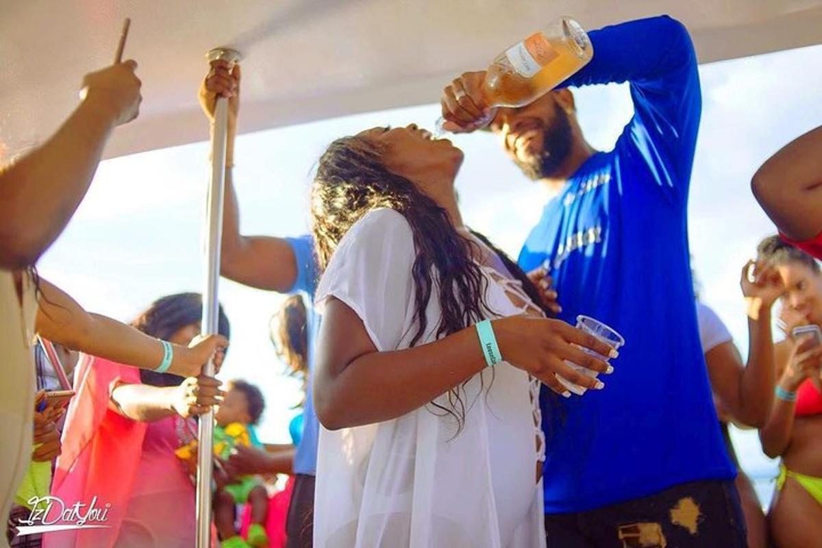a woman drinking a drink from a bottle