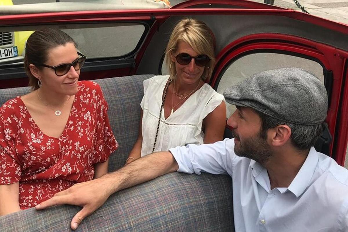 a man and two women sitting in a car