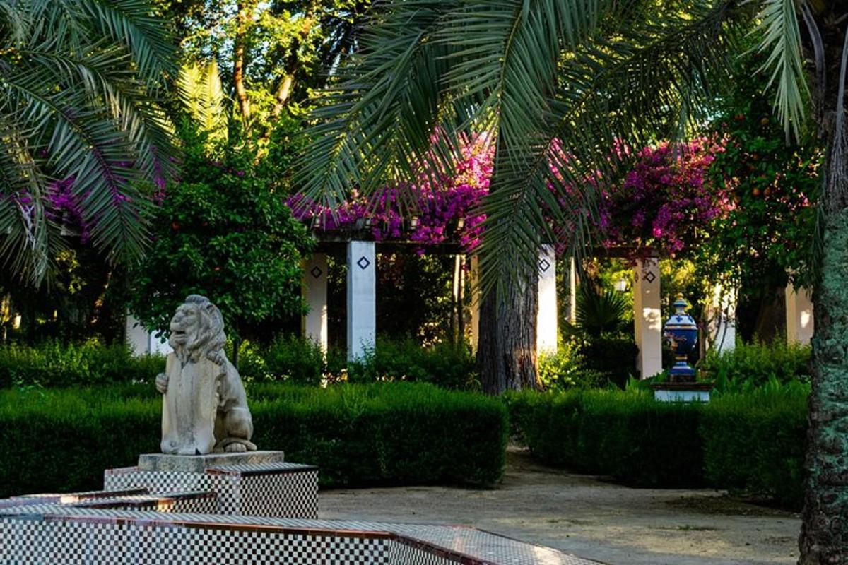 a statue of a lion in a garden with trees