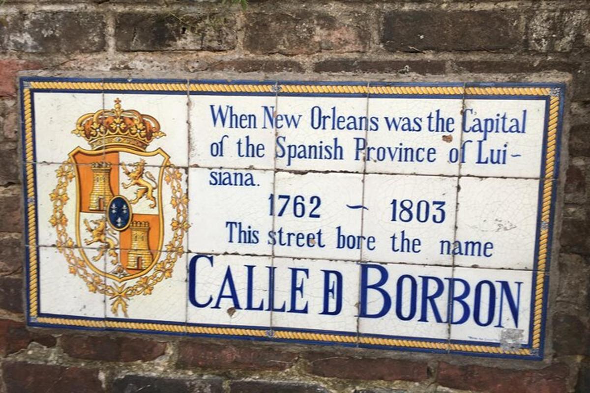 a sign on the side of a brick wall