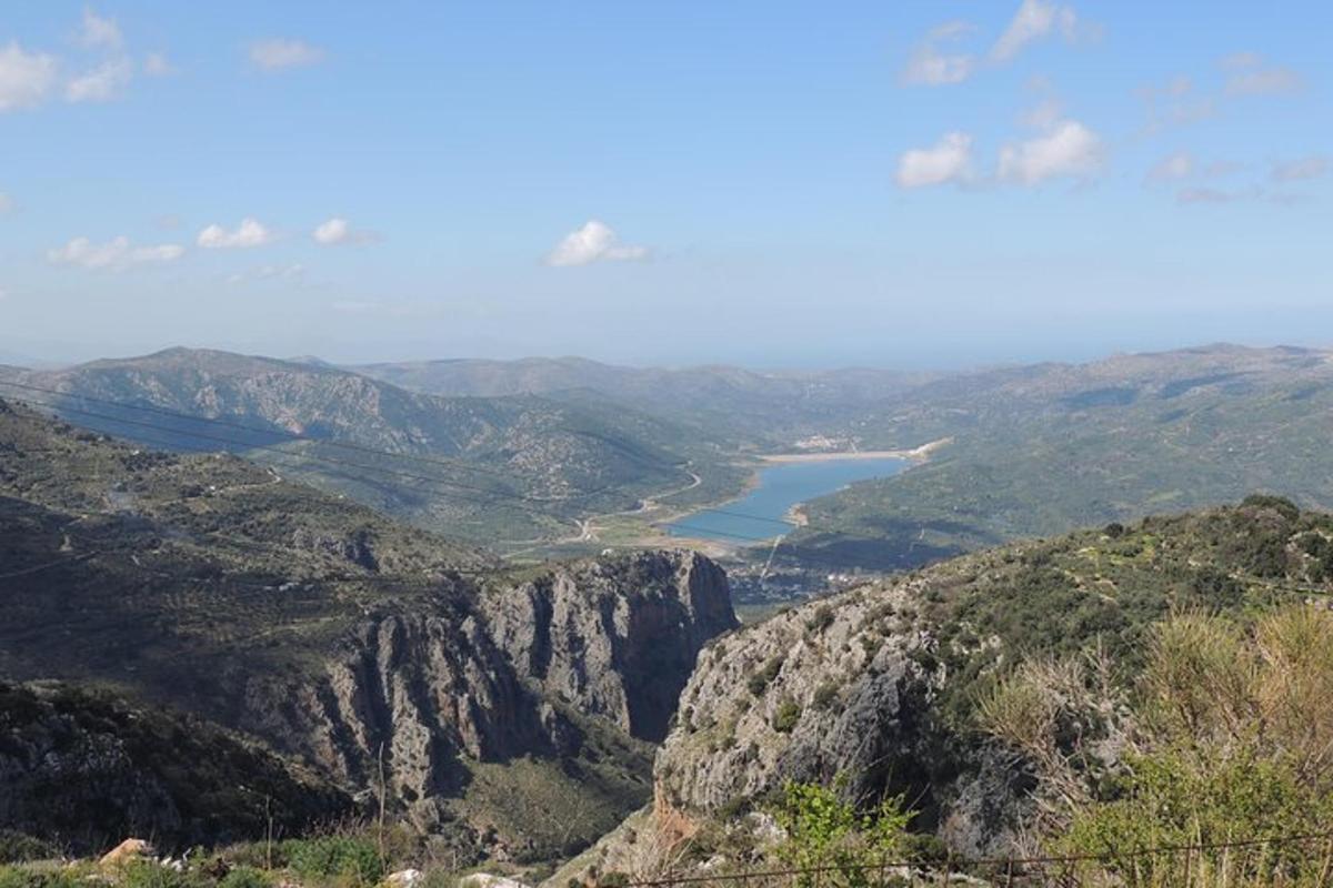 a view of a mountain with a lake in the distance