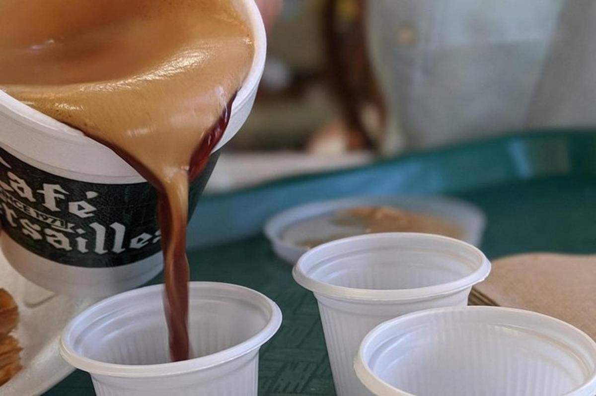 a drink is being poured into a cup on a table