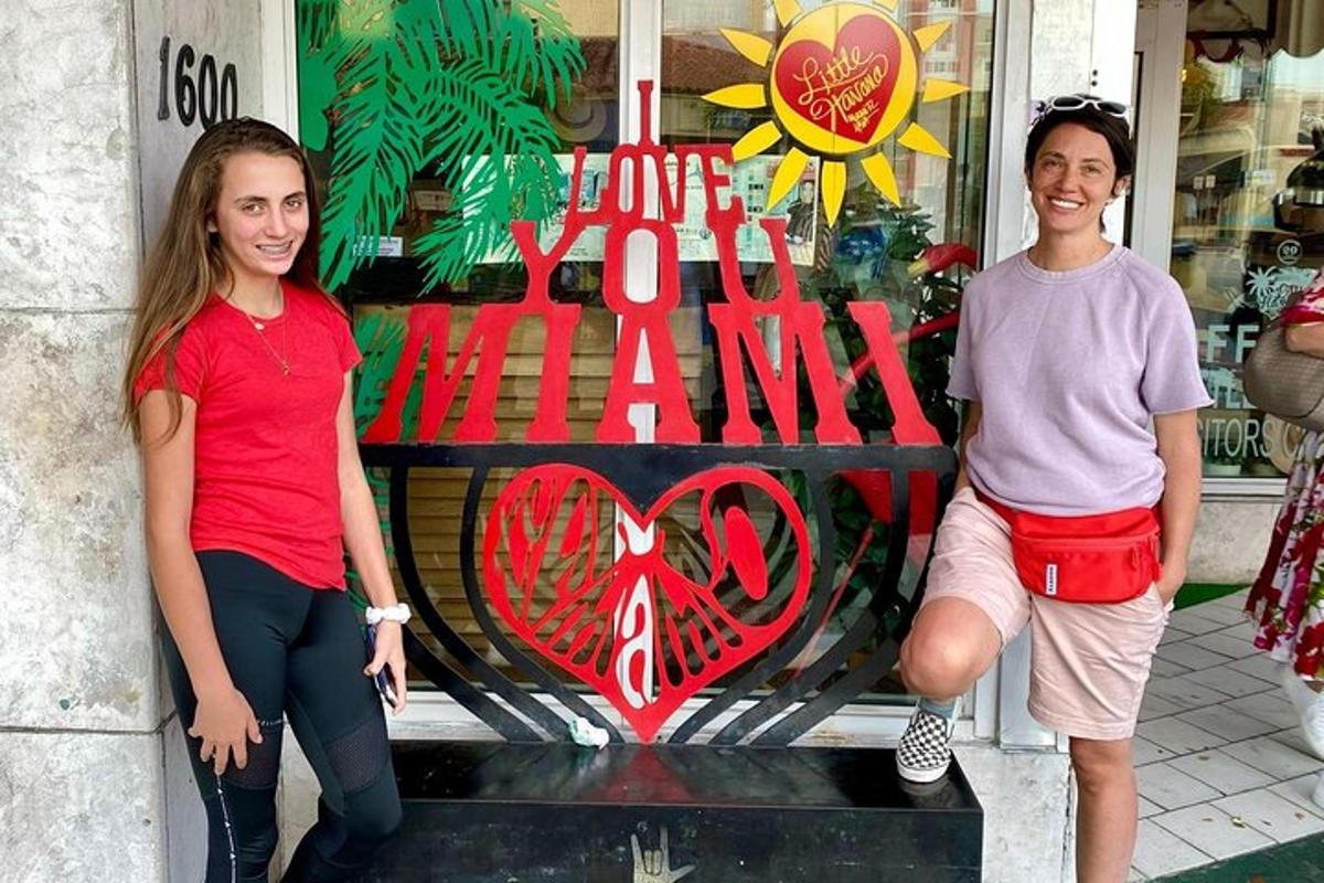 two women and a man standing in front of a store window
