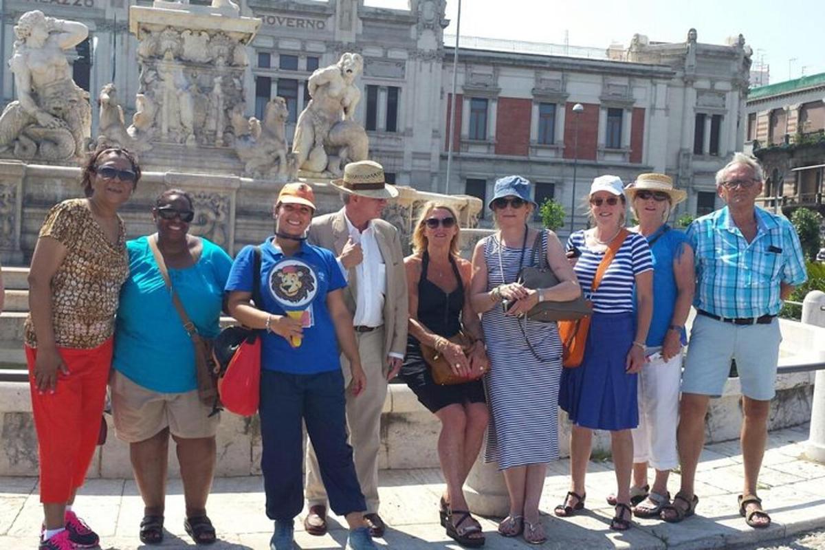 a group of people standing in front of a fountain