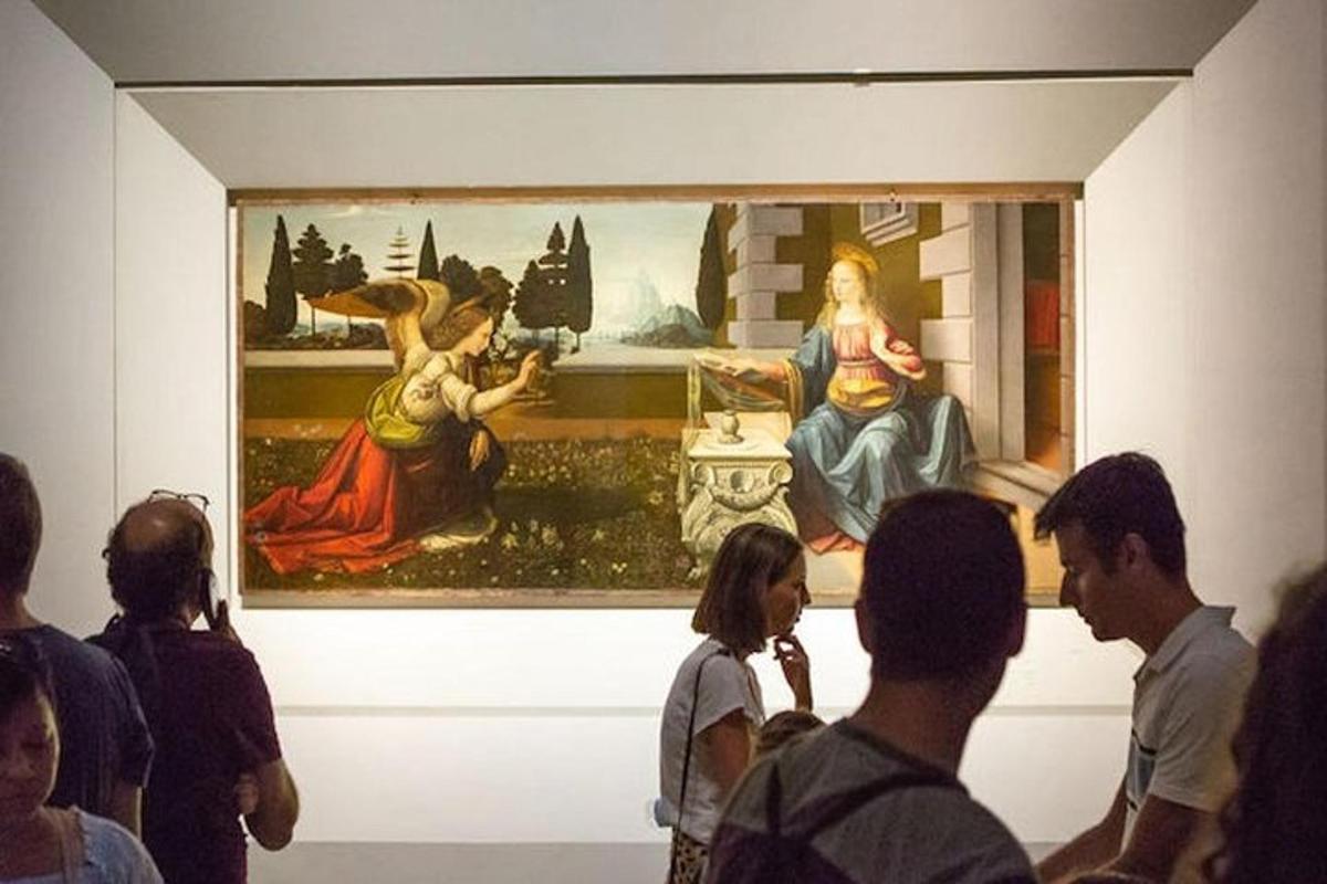 a group of people looking at a painting in a museum