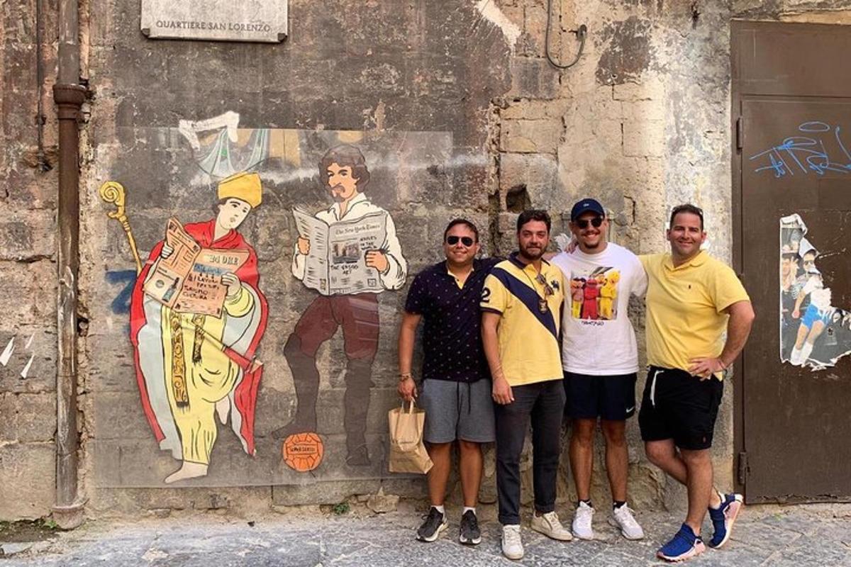 Un grupo de personas de pie frente a un mural.
