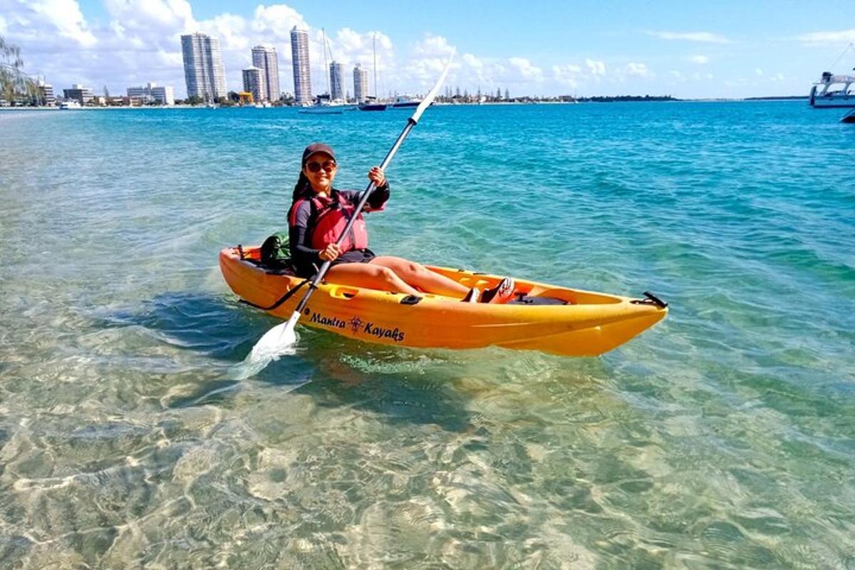 a woman is sitting in a kayak in the water