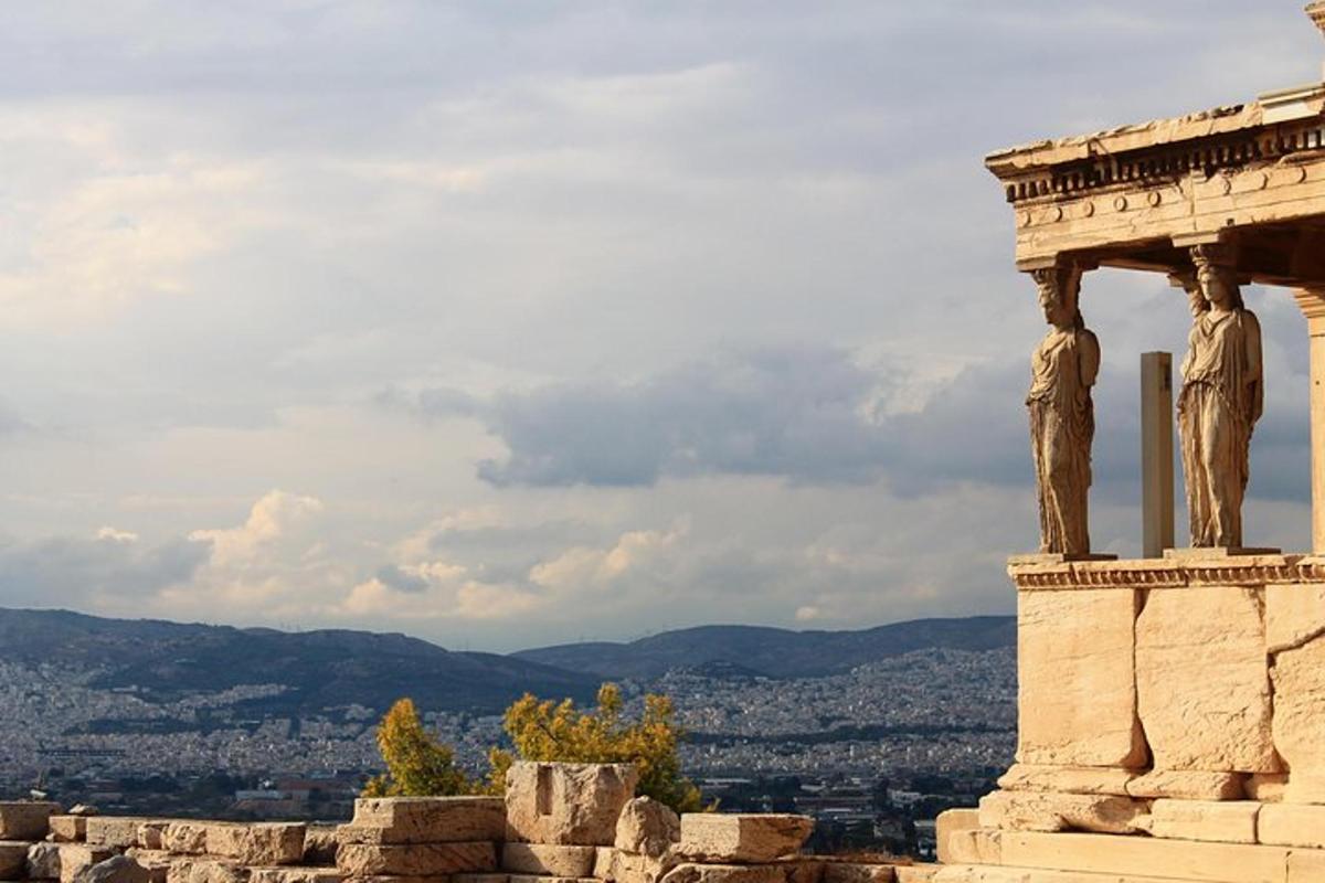 a stone building with two statues on top of it