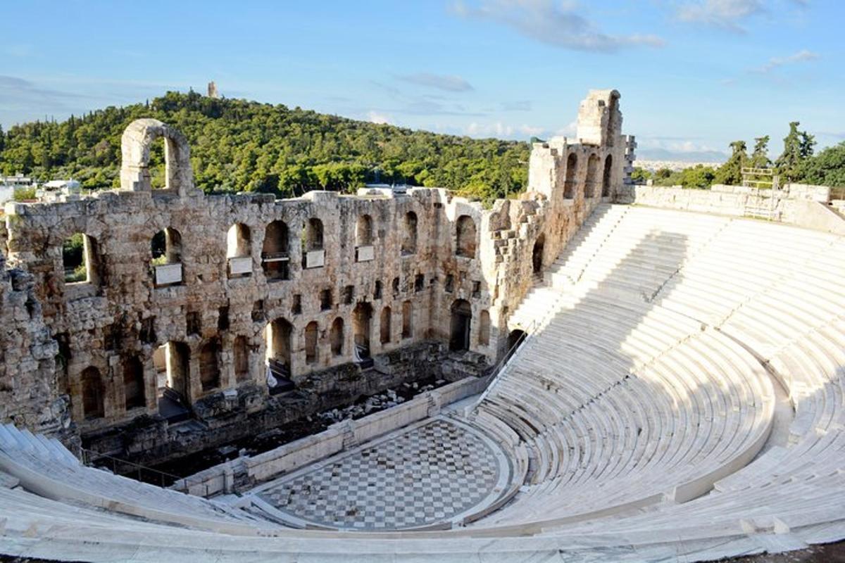 an empty amphitheater with a building in the background