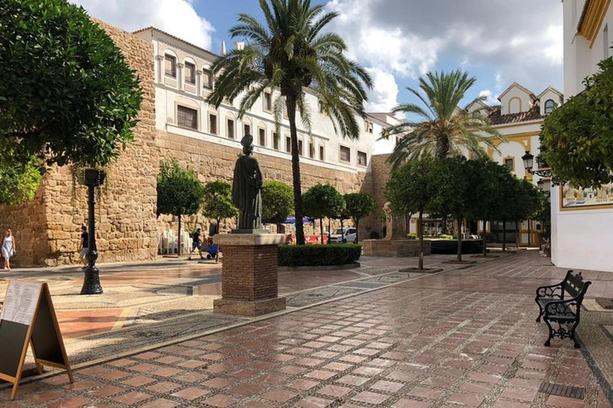 a statue in the middle of a street with a building