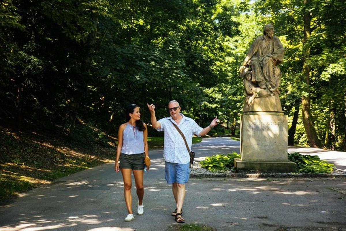 a man and a woman walking past a statue