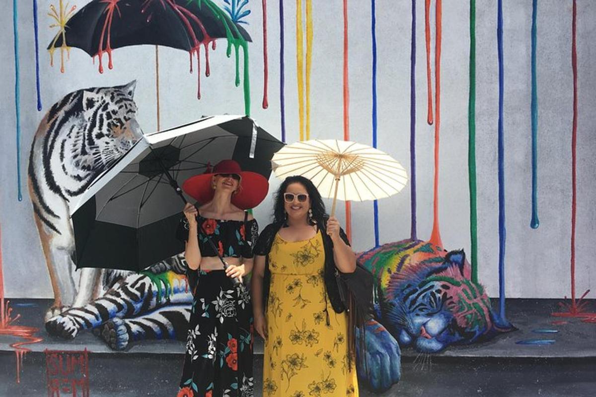 two women standing next to each other holding umbrellas