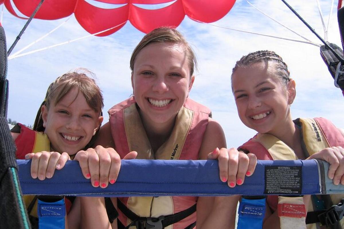 a group of three girls are holding onto a raft