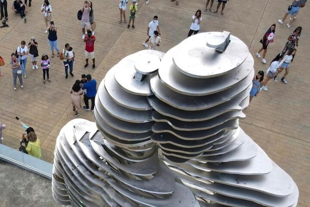 a stack of plates on top of a crowd of people