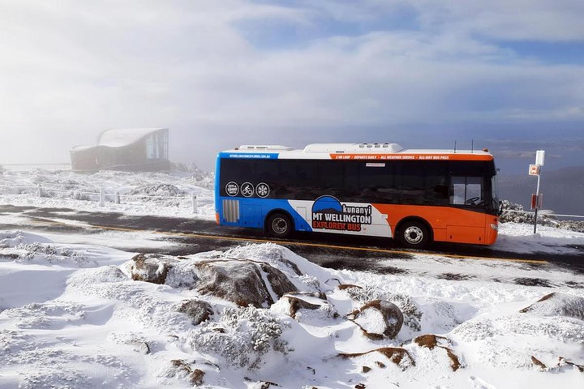 a bus driving down a road in the snow