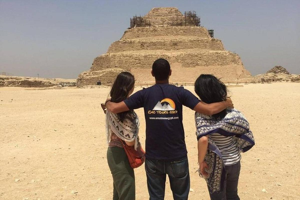a group of people standing in front of a pyramid