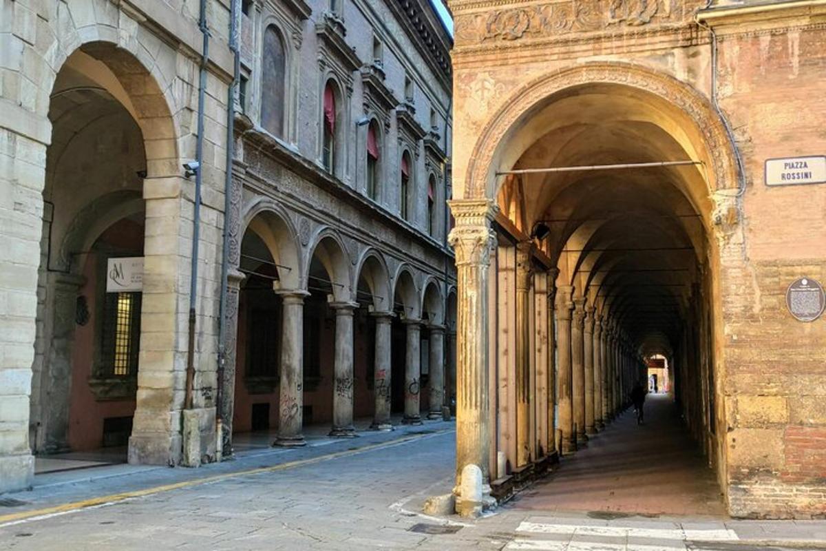 an alleyway in a building with arches on it