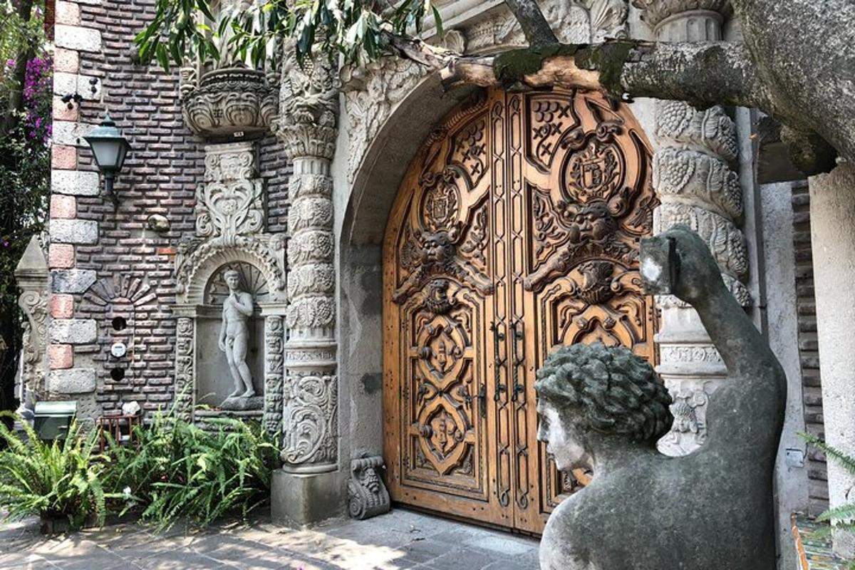 a statue in front of a large wooden door
