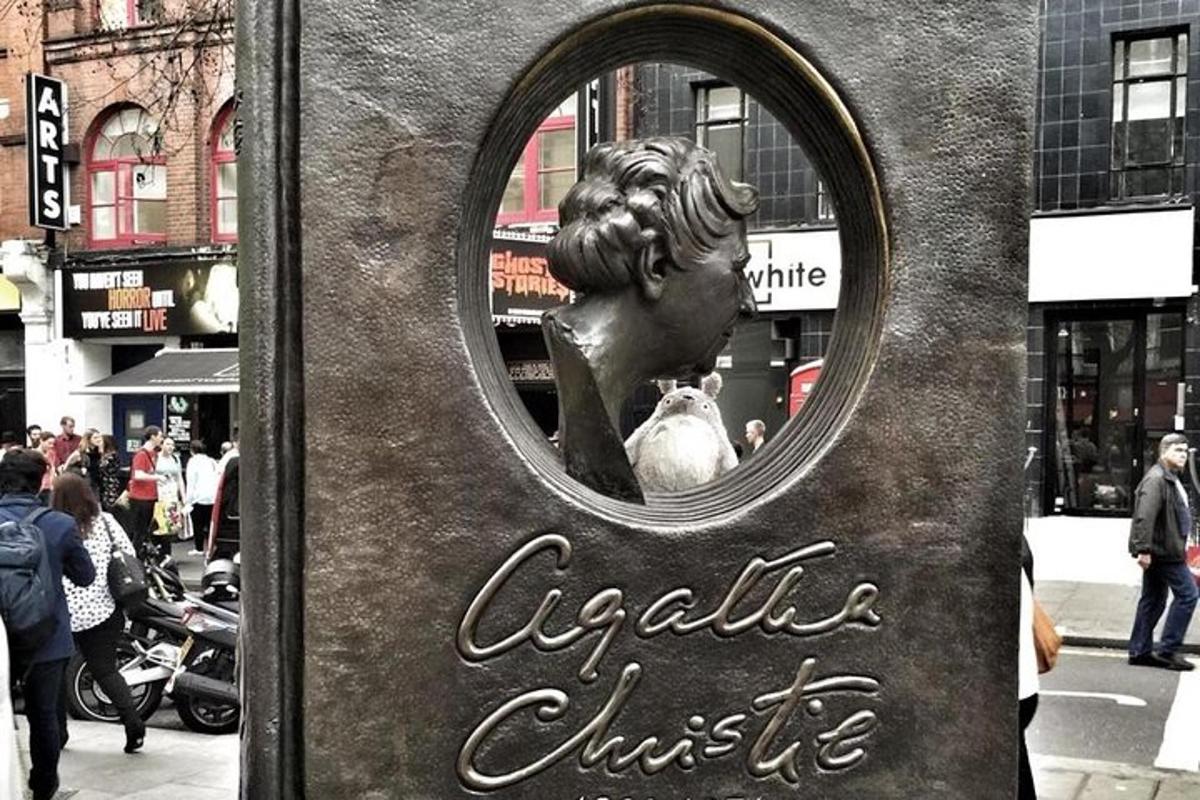 a statue of a woman in a mirror on a street
