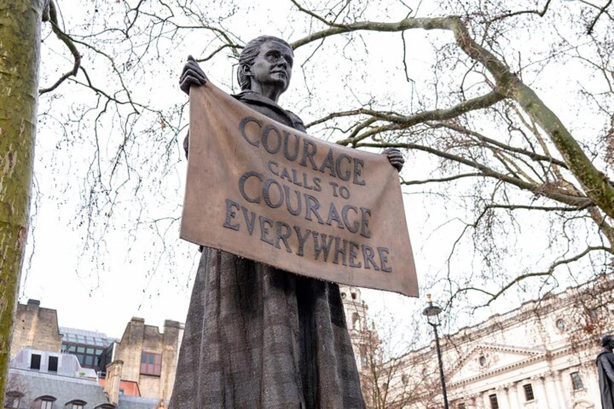 a statue of a man holding a sign