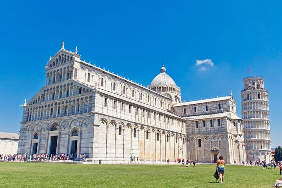 a woman standing in front of a building with the leaning tower