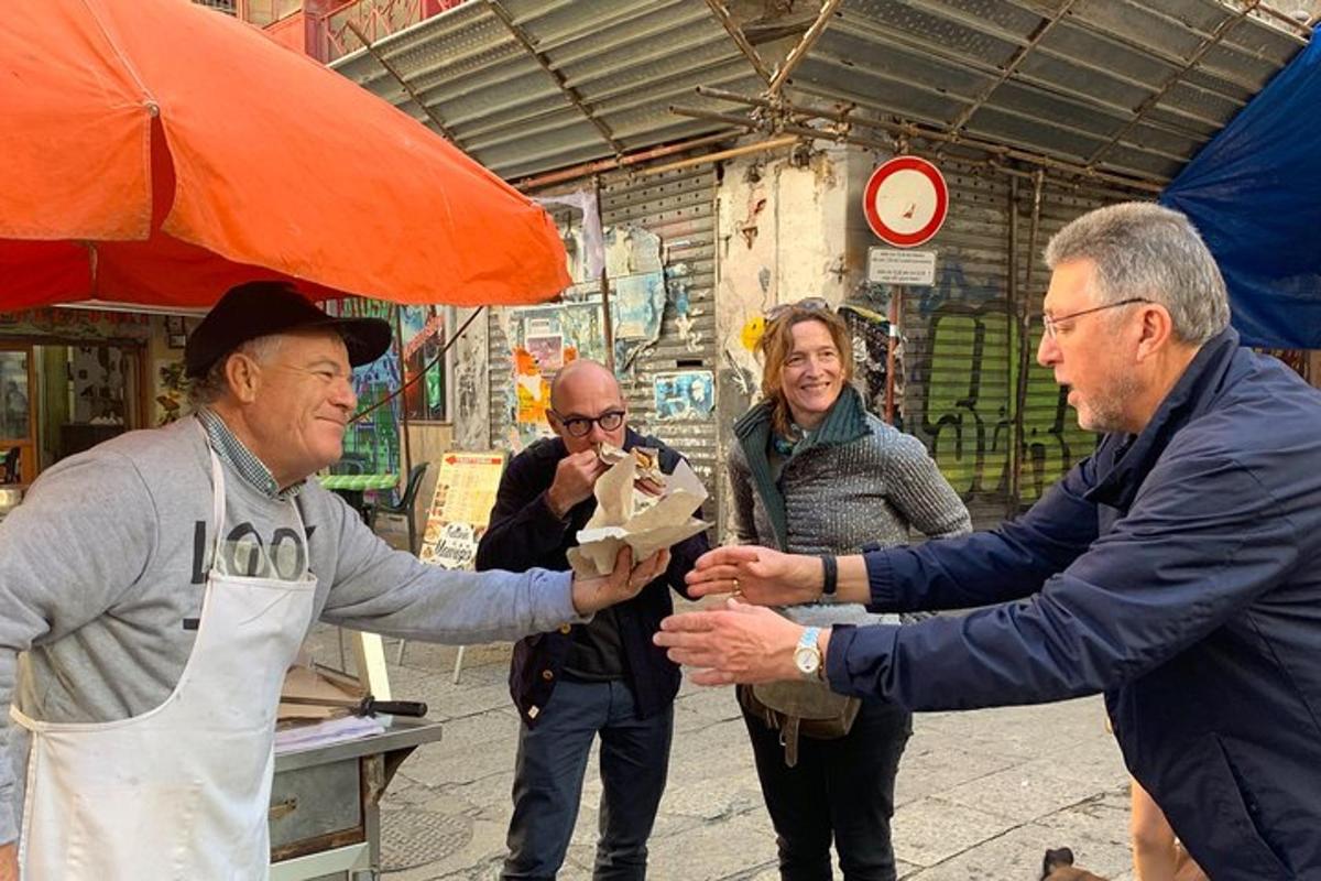 a man is handing a man a piece of food