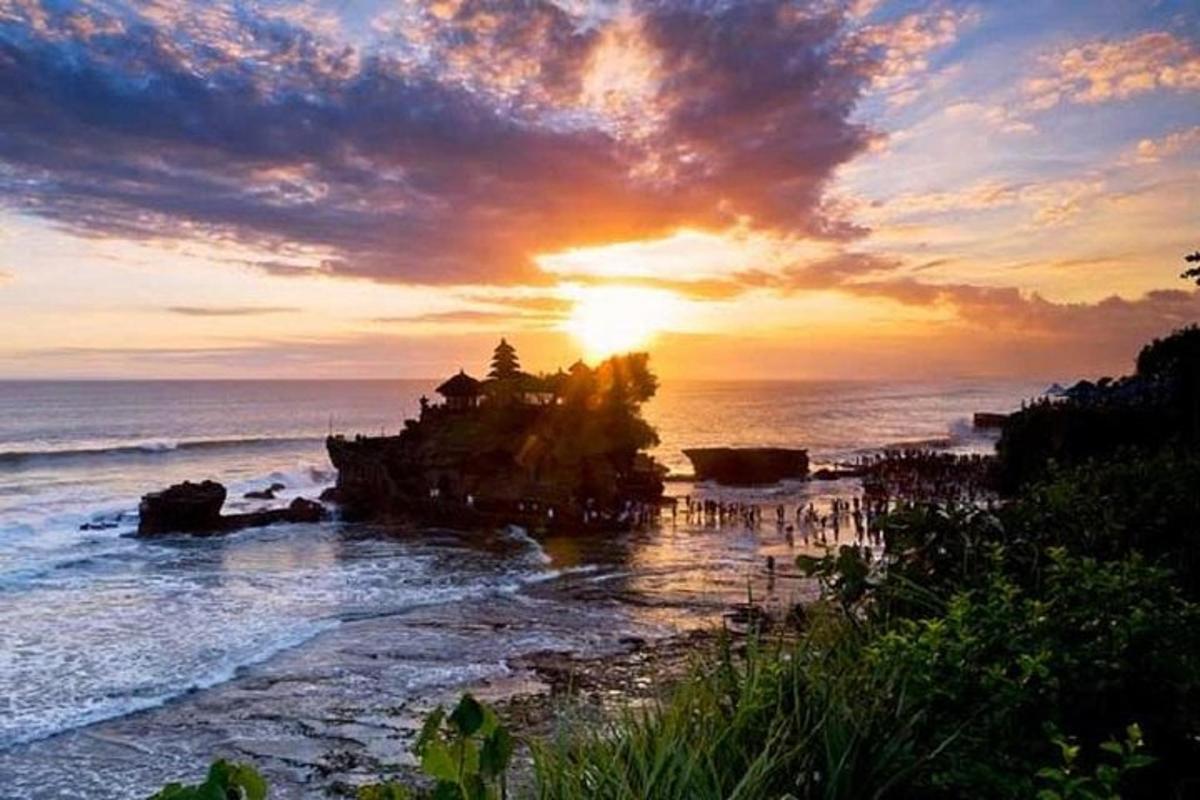 um pôr do sol na praia com o sol se pondo