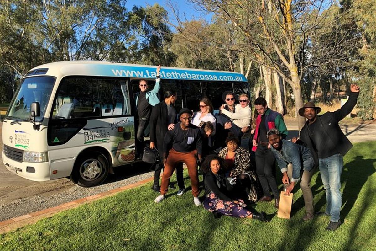 a group of people standing in front of a bus