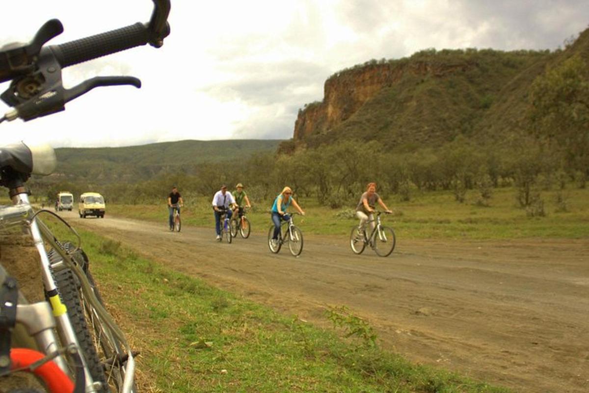 a group of people riding bikes down a dirt road