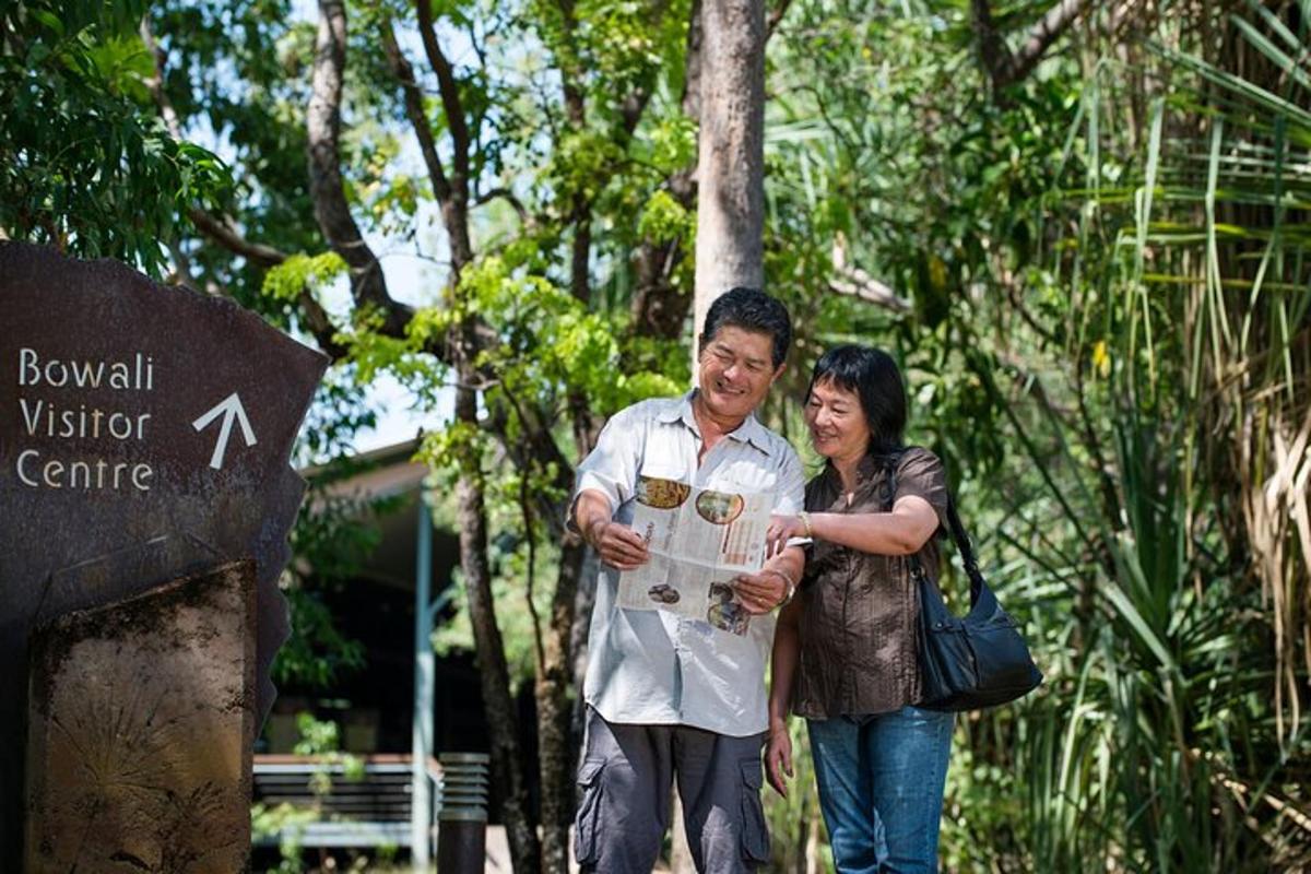 a man and a woman standing in front of a sign