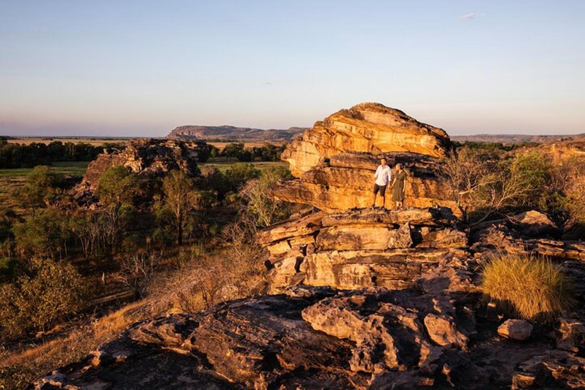 a man standing on top of a rock