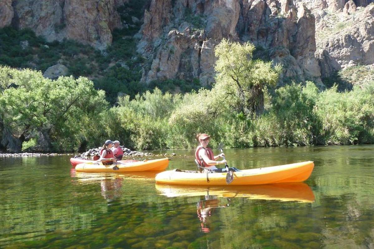 a group of people in kayaks on a river