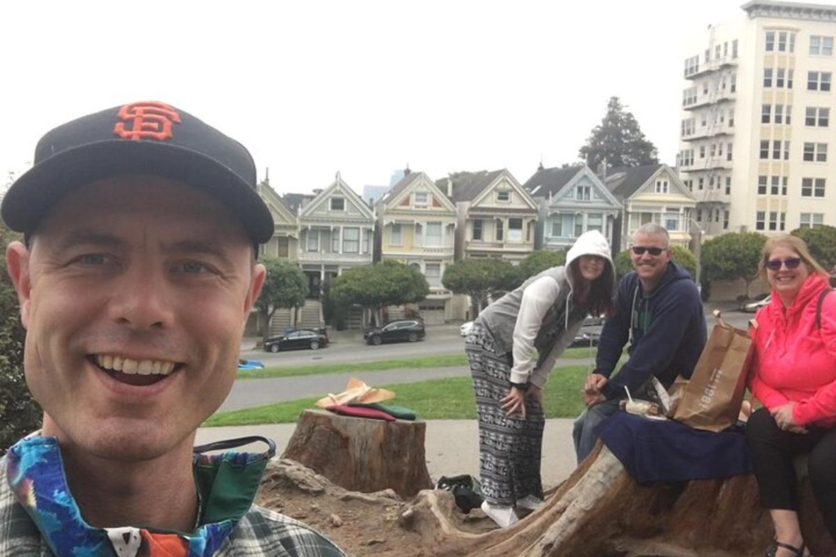 a group of people standing around a tree stump