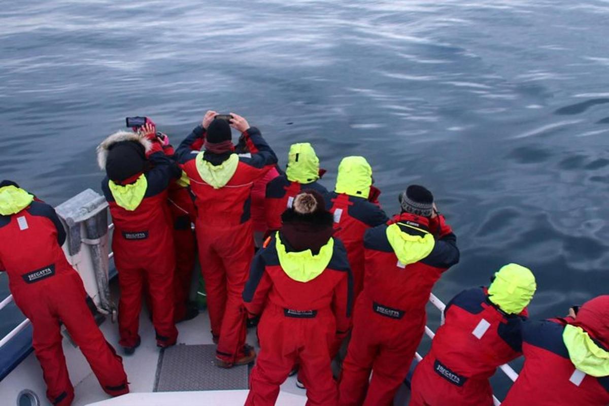 Un grupo de personas de pie en un bote en el agua.