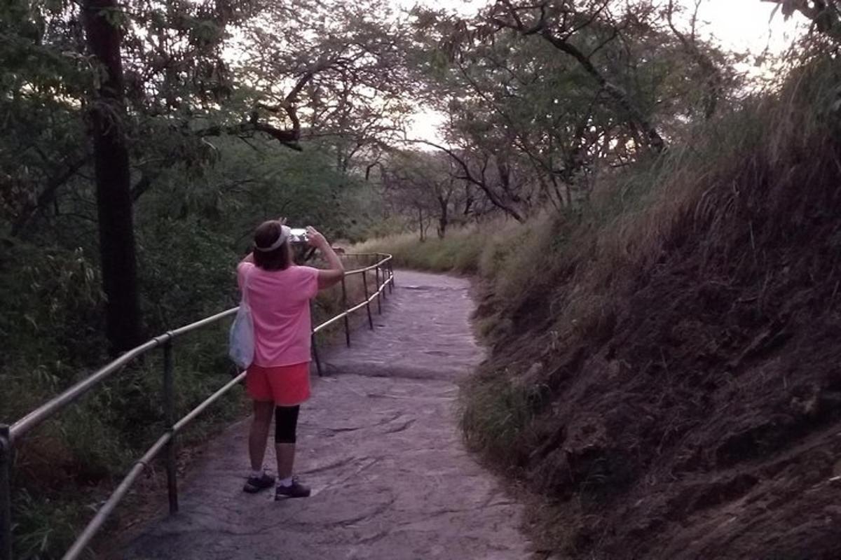 a woman taking a picture of a path