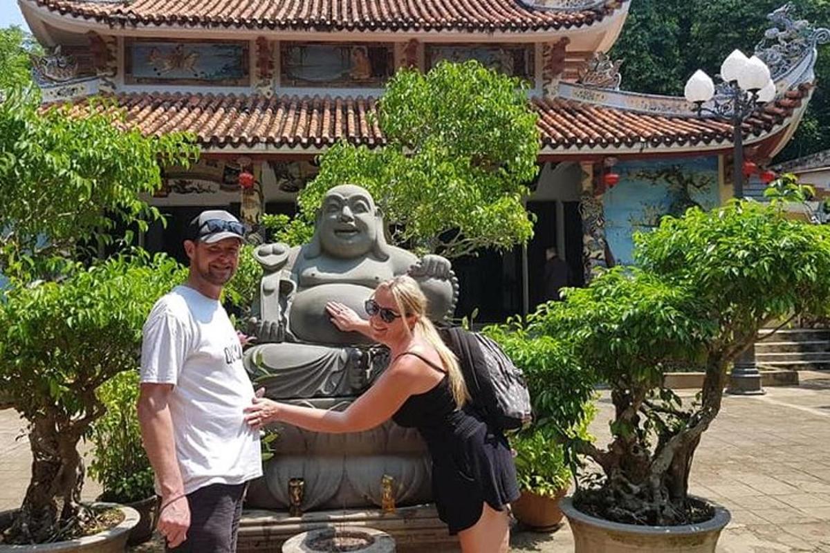 um homem e uma mulher em pé em frente a uma estátua