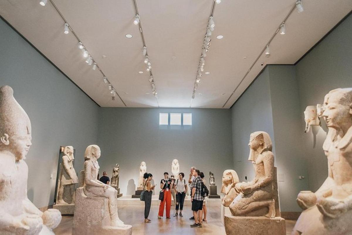 a group of people standing in a museum with statues