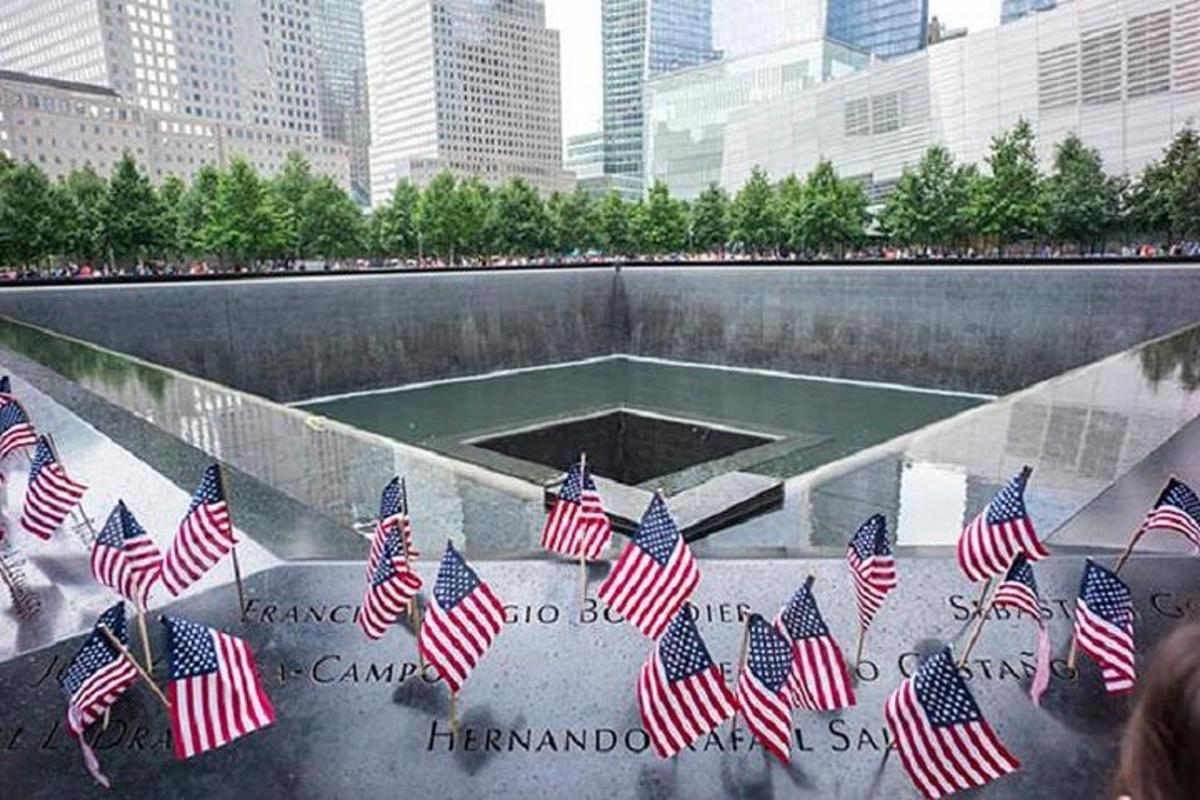 a group of american flags in front of a monument